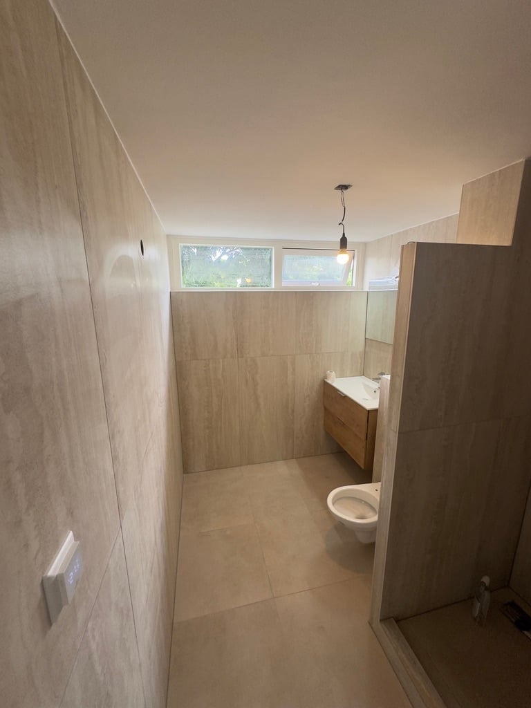 Moderne gerenoveerde badkamer in Oss met houtlook en strak design
