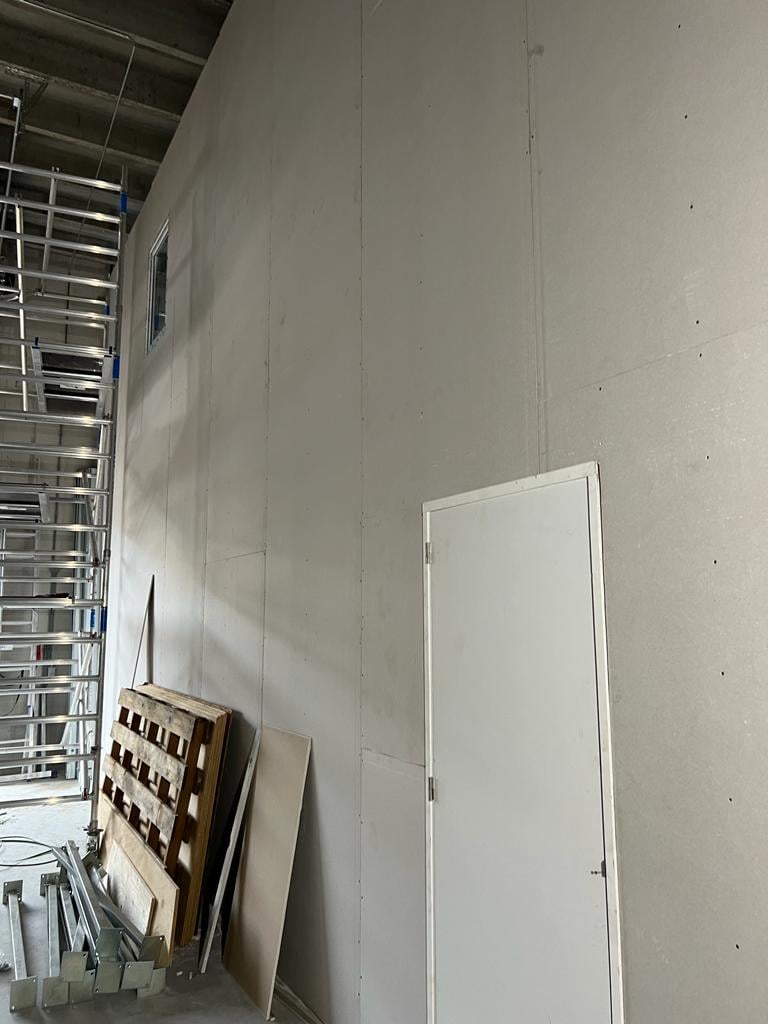 Hoge scheidingswand in aanbouw voor de indeling van een bedrijfsruimte